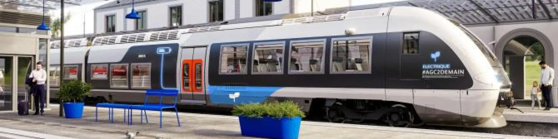 Modern train at the station with passengers waiting on the platform