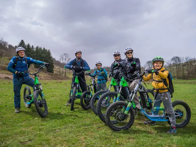 A family with electric bikes on a country path