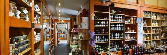 Wooden shelves filled with jars and bottles of artisanal products