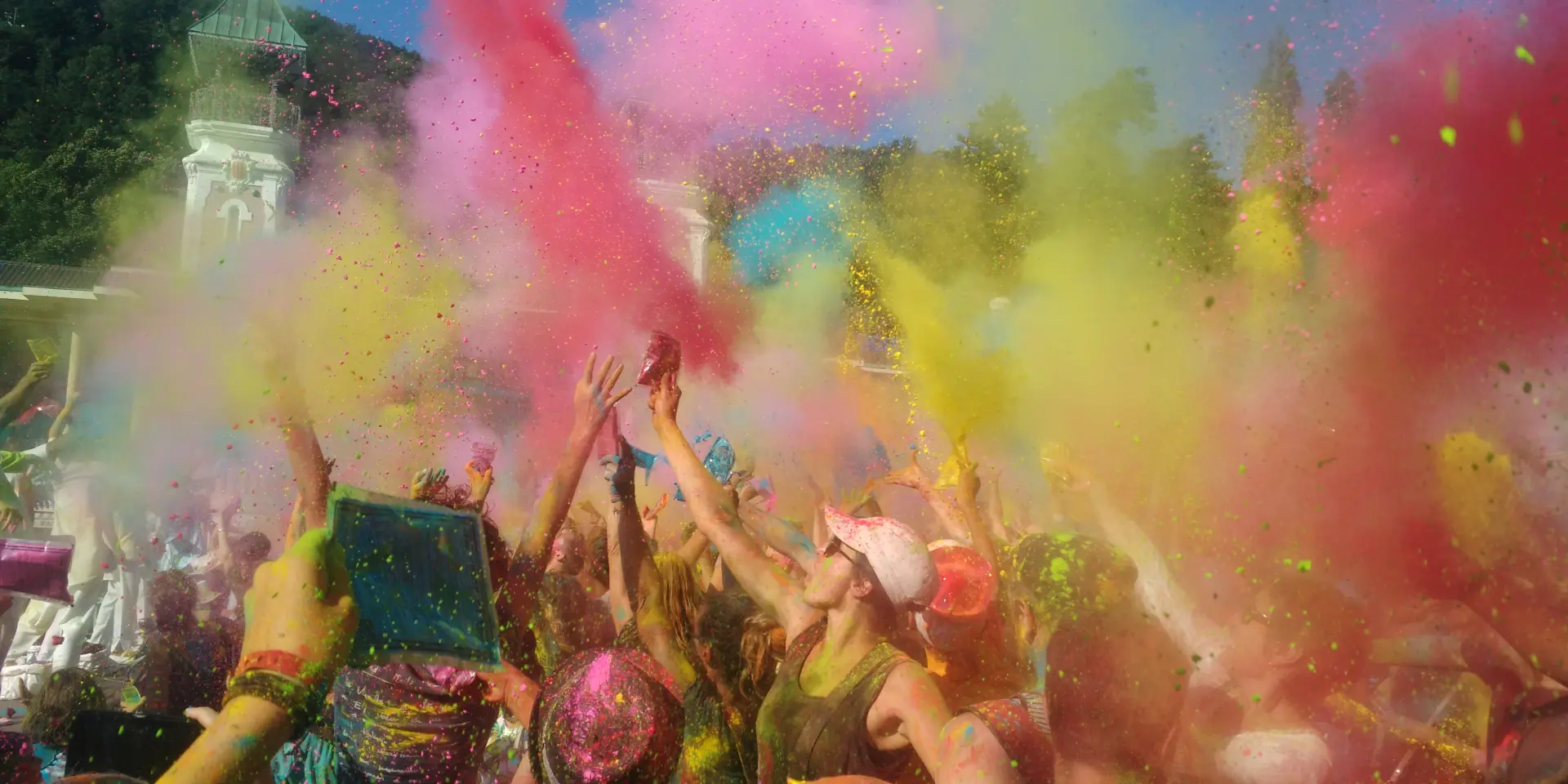 Groupe de personnes lançant des poudres colorées lors d'une fête des couleurs