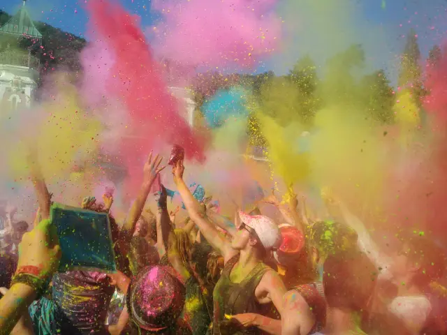 Group of people throwing colored powders during a color festival