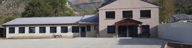 Mountain building with a blue sky and trees