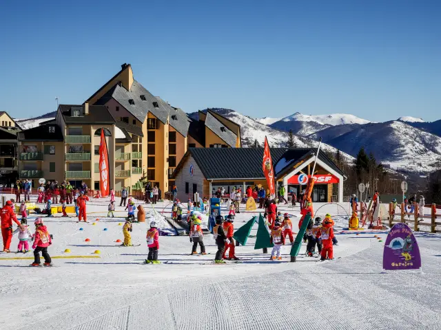 Children taking skiing lessons with instructors at a ski resort