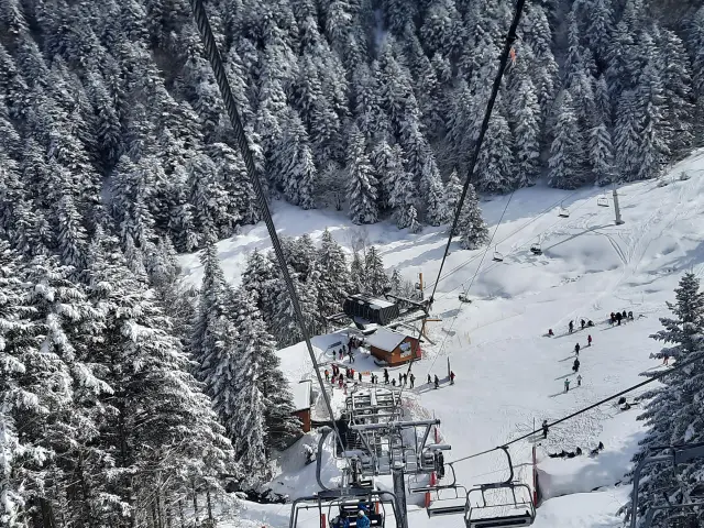 Ski slope with ski lift and skiers