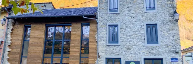 Stone building with a modern facade and accessibility signs