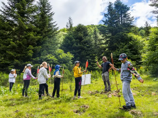 A group of people hiking in a green forest