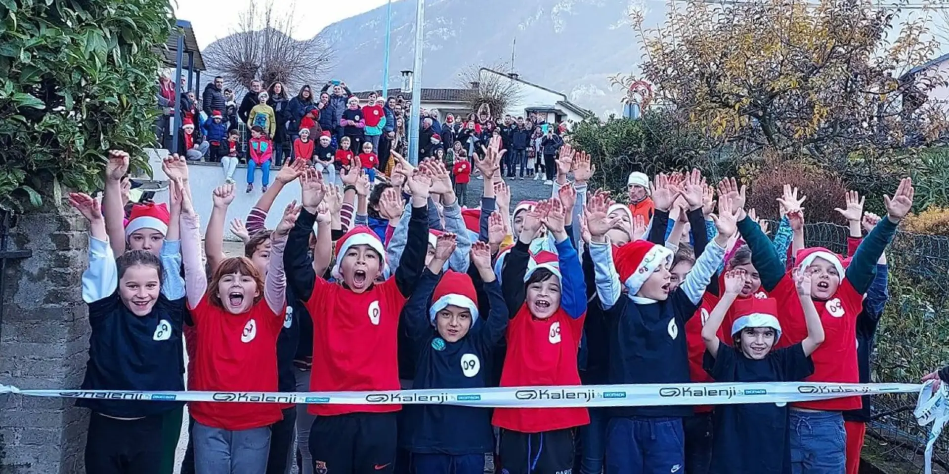 Groupe d'enfants en uniforme sportif levant les bras en signe de victoire